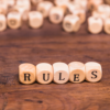 Wooden blocks spelling RULES representing the 51 percent redevelopment consent rule