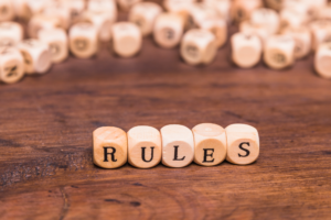 Wooden blocks spelling RULES representing the 51 percent redevelopment consent rule